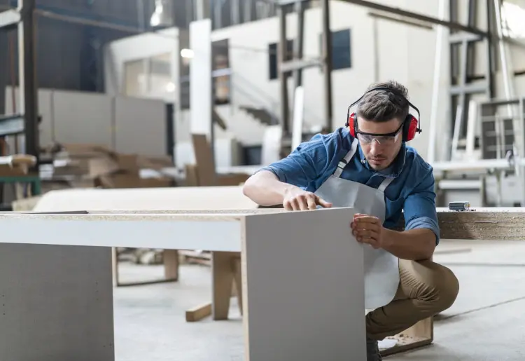 Skilled carpenter making cabinet in workshop A Man Working on Making Closet Parts