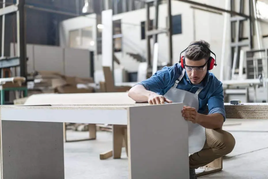 A Man Working on Making Closet Parts
